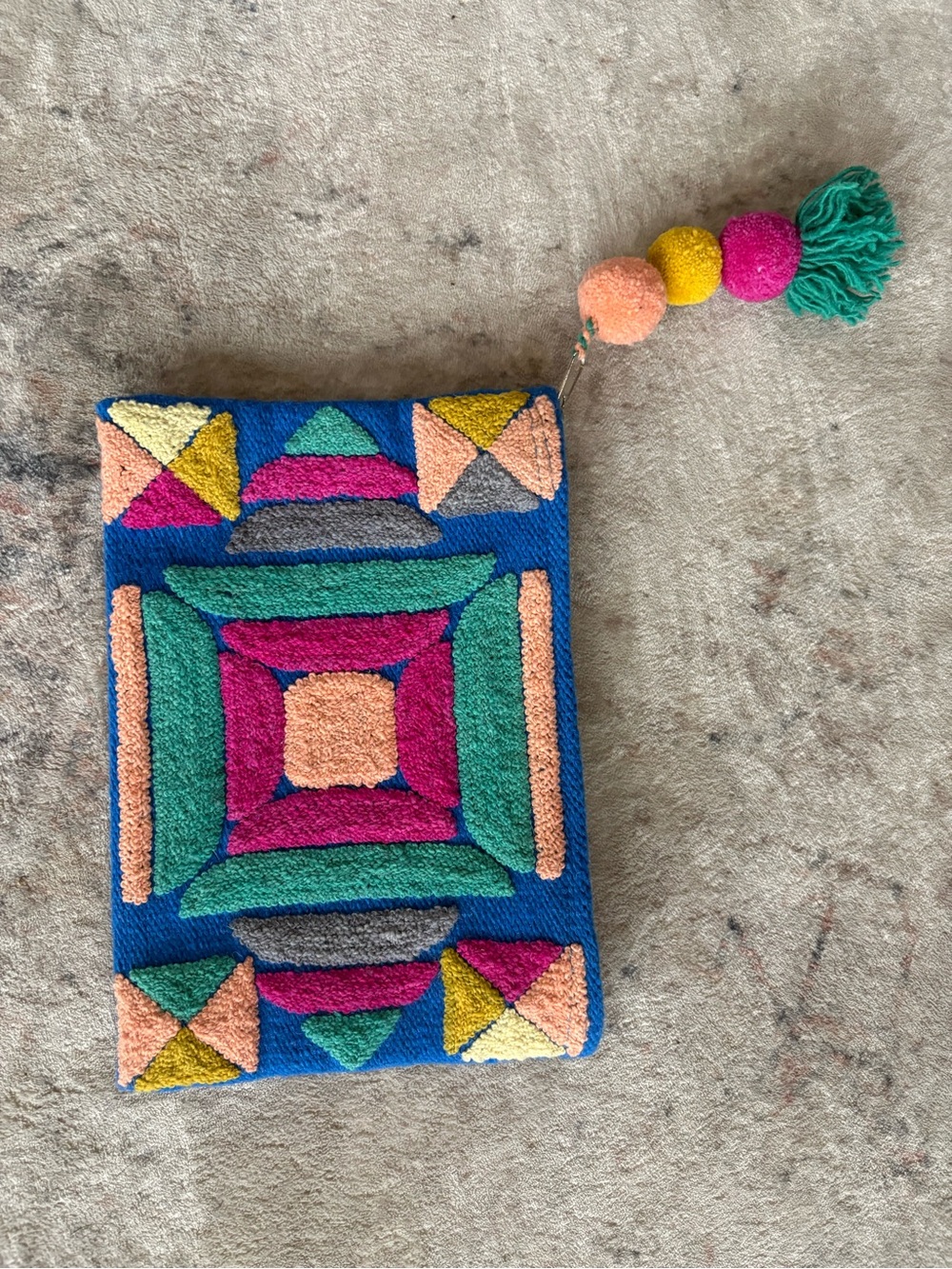 Noonday Collection Multicolor Geometric Tufted Clutch with Pom Tassel